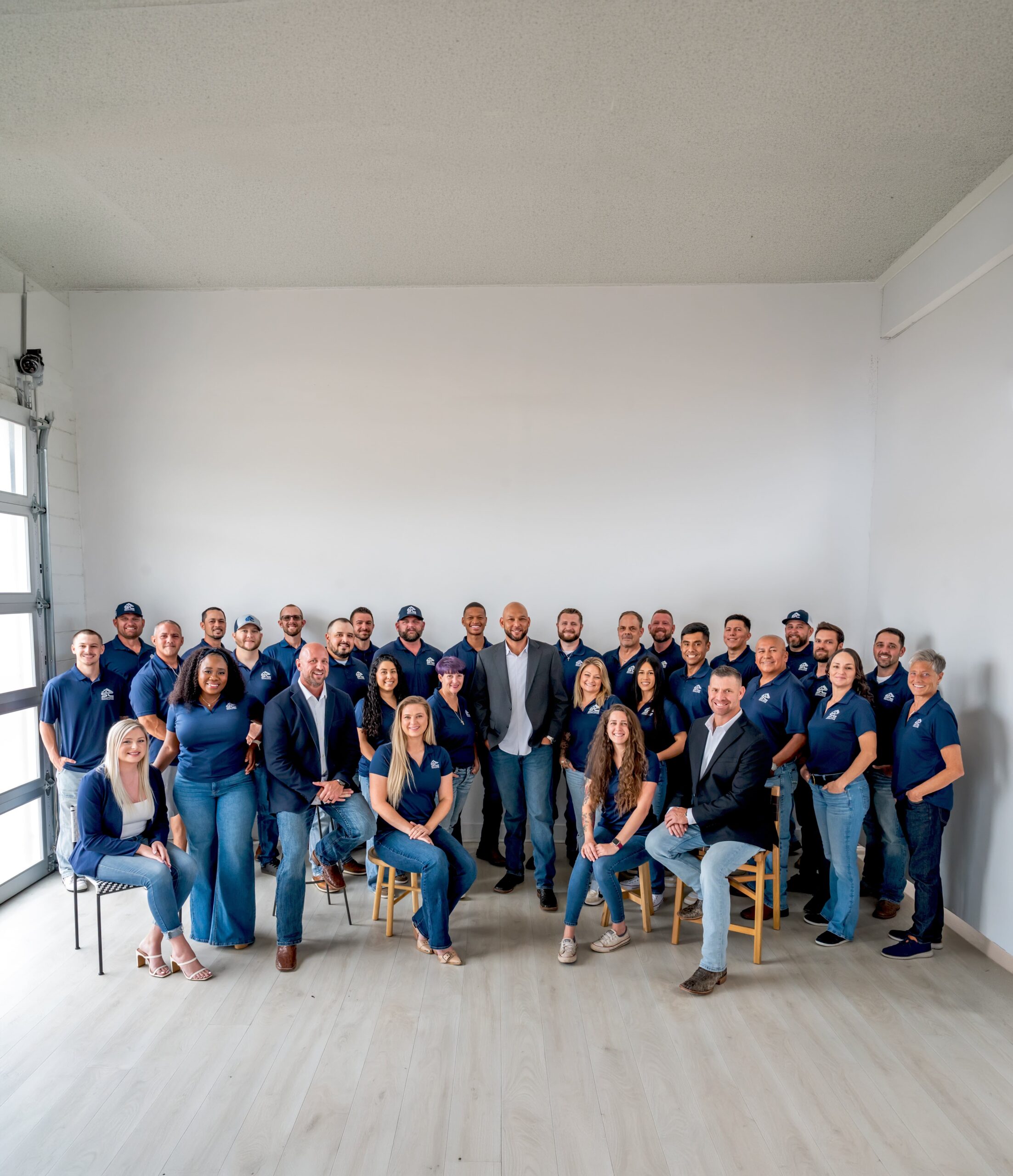 The Solutions Contracting team standing and seated together in an office
